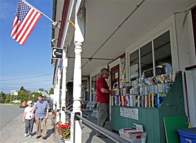 This Sept. 14, 2011 photo shows the front of the Hastings Store in West Danville, Vt. At Hastings Store, owner Garey Larrabee is also the postmaster and cook, running a full-service Post Office and cooking up old-fashioned donuts for the regulars who come in to catch up on gossip and pick up mail, lingering around the wall of boxes with the three-digit dial combination locks. (AP Photo/Toby Talbot)